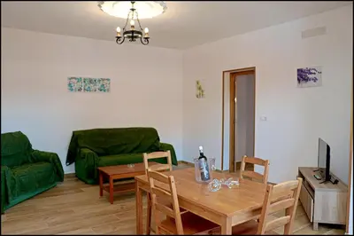 a living room with a table and a green couch at Chalet Maestro in Roche