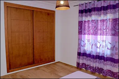 a room with a wooden cabinet and a curtain at Chalet Maestro in Roche
