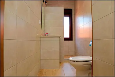 a bathroom with a toilet and a window at Chalet Maestro in Roche