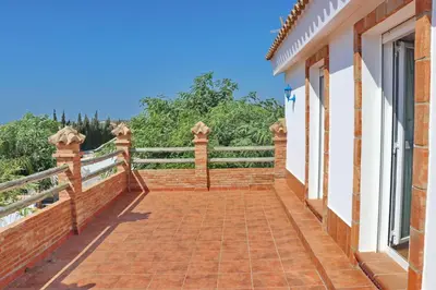 a balcony of a house with a brick walkway at Chalet Pradillo II in Conil de la Frontera