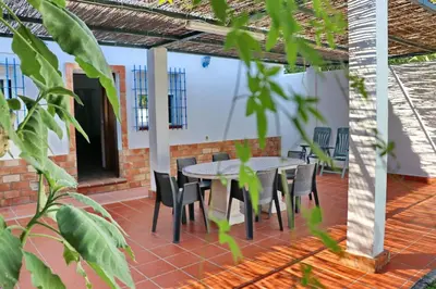 a patio with a table and chairs on it at Chalet Pradillo II in Conil de la Frontera
