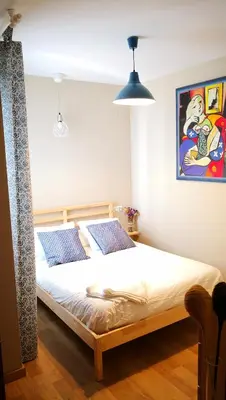 a bedroom with a bed and a painting on the wall at Zambra. Luminoso y coqueto apartamento en Chiclana in Chiclana de la Frontera