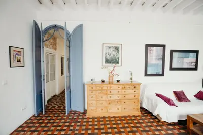 a bedroom with a bed and a dresser at Apartamento El Balcon de Cadiz in Cádiz