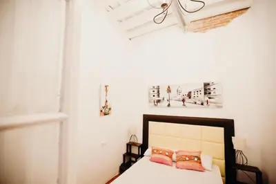 a bedroom with a bed with two pillows on it at Apartamento El Balcon de Cadiz in Cádiz