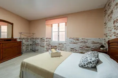 a bedroom with a bed with a dresser and a mirror at Apartamento Maribel in Cádiz