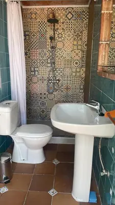 a bathroom with a toilet and a sink at Macondo La barrosa in Chiclana de la Frontera