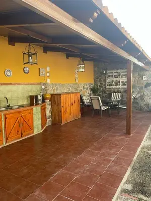 a patio with a kitchen and a table and chairs at Macondo La barrosa in Chiclana de la Frontera