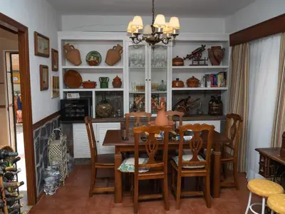 a dining room with a table and chairs at Macondo La barrosa in Chiclana de la Frontera