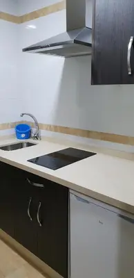 a kitchen with a sink and a stove at Hostal Málaga in Arcos de la Frontera