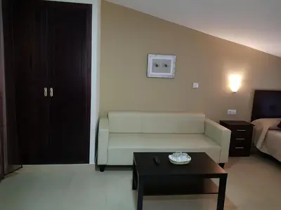 a living room with a couch and a coffee table at Hostal Málaga in Arcos de la Frontera