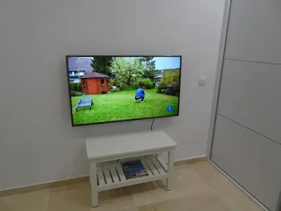 a flat screen tv on a wall in a living room at Loft Playa Santa María (Cádiz) in Cádiz
