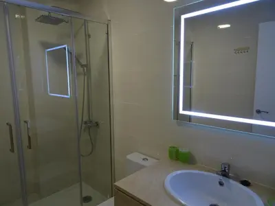 a bathroom with a shower and a sink and a mirror at Loft Playa Santa María (Cádiz) in Cádiz