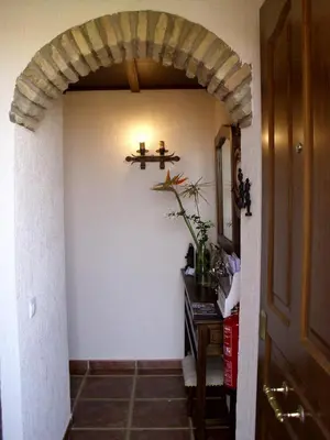 an entrance to a hallway with a stone archway at La Posada de Menchu in Sanlúcar de Barrameda