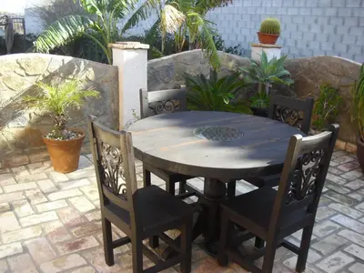 a wooden table and chairs on a patio at La Posada de Menchu in Sanlúcar de Barrameda