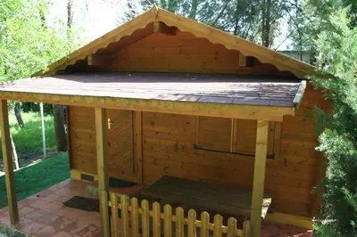 a couple of small wooden buildings in the woods at Bungalows y Glamping Medina Sidonia in Medina Sidonia