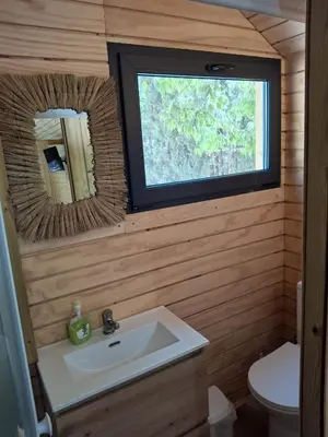 a tent with two beds and a tv in it at Bungalows y Glamping Medina Sidonia in Medina Sidonia
