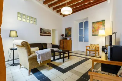 a kitchen with a wooden table and red cabinets at GuestReady - Arbolí Cadiz in Cádiz