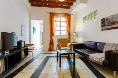 a dining room with a wooden table and chairs at GuestReady - Arbolí Cadiz in Cádiz
