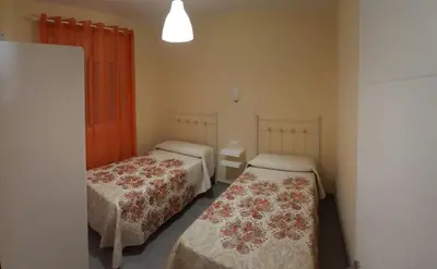 two beds in a small room with at Casa los Naranjos 1 in Conil de la Frontera