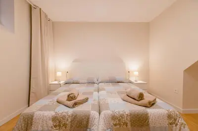 a bedroom with a large bed with two pillows on it at Apartamento Duplex La Estrella in Cádiz