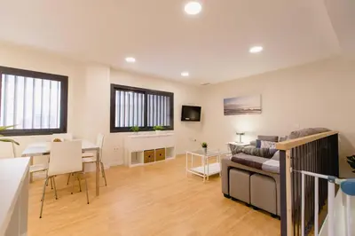 a living room with a couch and a table at Apartamento Duplex La Estrella in Cádiz