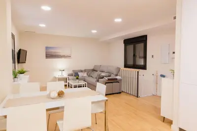 a living room with a couch and a table at Apartamento Duplex La Estrella in Cádiz