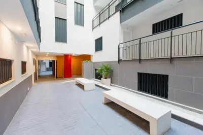 an empty hallway of a building with benches at Apartamento Duplex La Estrella in Cádiz