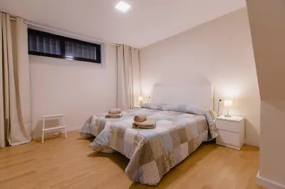 a bedroom with a bed with two towels on it at Apartamento Duplex La Estrella in Cádiz