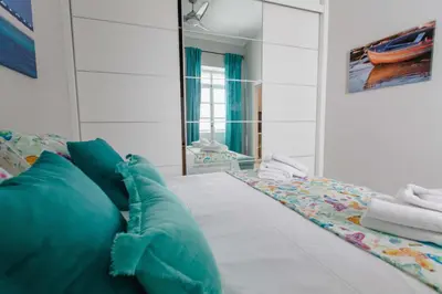 a bedroom with a bed with a mirror at Apartamento La Casa del Almirante in Cádiz