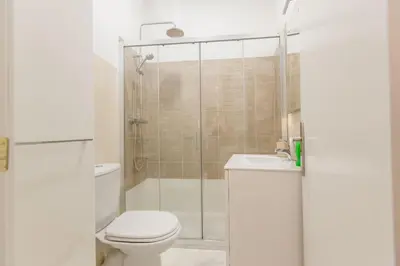 a bathroom with a shower and a toilet and a sink at Apartamento La Casa del Almirante in Cádiz