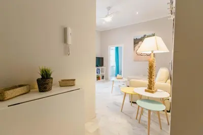 a living room with a table and a couch at Apartamento La Casa del Almirante in Cádiz