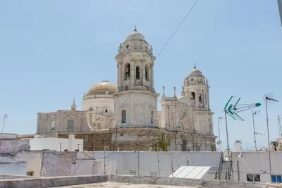 an old building with two towers on top of it at Apartamento La Casa del Almirante in Cádiz