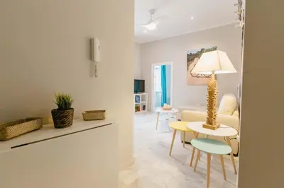 a living room with a table and a couch at Apartamento La Casa del Almirante in Cádiz