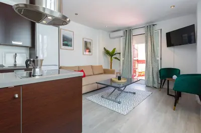 a kitchen and living room with a couch and a table at Atico de los FRANCESES by Cadiz4Rentals in Cádiz