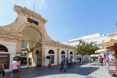 a group of people walking in front of a building at Atico de los FRANCESES by Cadiz4Rentals in Cádiz