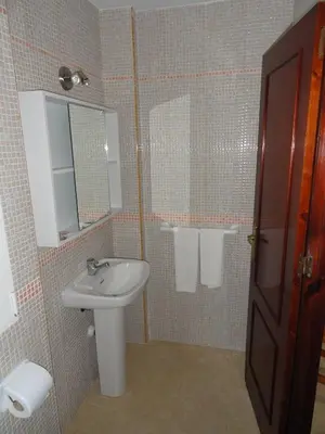 a bathroom with a sink and a mirror at Hostal la Campa in Chiclana de la Frontera