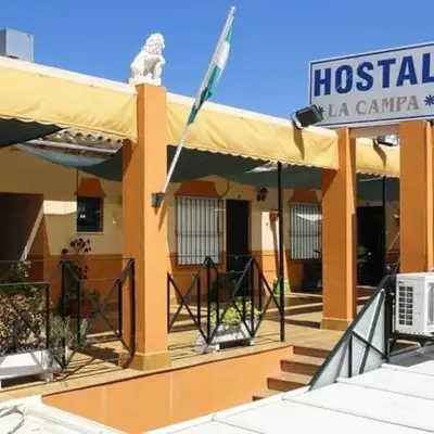 a hospital building with a flag on top of it at Hostal la Campa in Chiclana de la Frontera