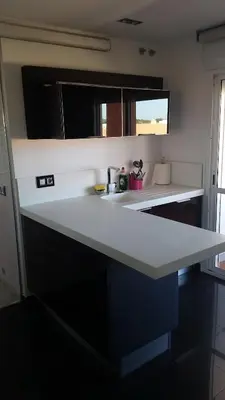a kitchen with a white counter and a sink at Espectacular ático en 1°linea playa in Rota