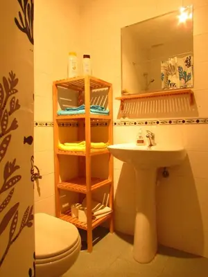 a bathroom with a sink and a toilet and a mirror at Mi pequeño apartamento in Cádiz