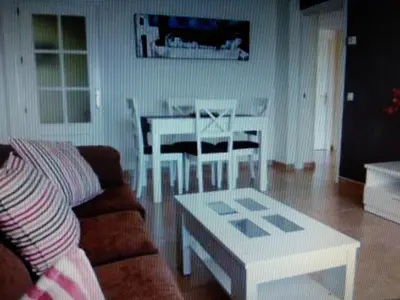 a living room with a couch and a table at VIVIENDA TURISTICA MARANt 2 in El Puerto de Santa María
