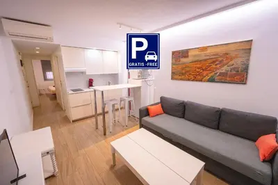 a living room with a couch and a kitchen at Alameda apodaca in Cádiz