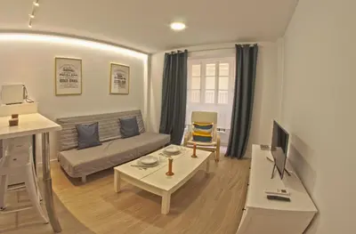 a living room with a couch and a table at Alameda apodaca in Cádiz