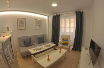 a living room with a couch and a table at Alameda apodaca in Cádiz