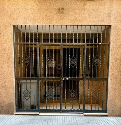 a window with an iron gate on a building at Alameda apodaca in Cádiz