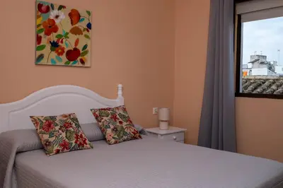 a bedroom with a white bed and a window at Sanvi Xerez Centro in Jerez de la Frontera