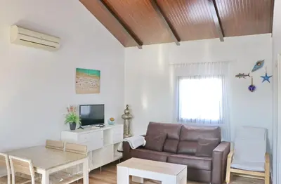 a living room with a couch and a table at Bungalow Ramos in Conil de la Frontera