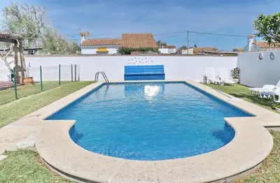 a swimming pool in the backyard of a house at Bungalow Ramos in Conil de la Frontera