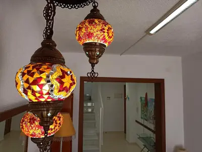 two stained glass lights hanging from a ceiling at Apartamentos Coralba - Dúplex Bahía de Cádiz in San Fernando