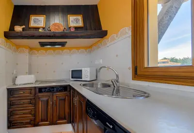 a kitchen with a sink and a microwave at Apartamentos Villafaro Conil in Conil de la Frontera