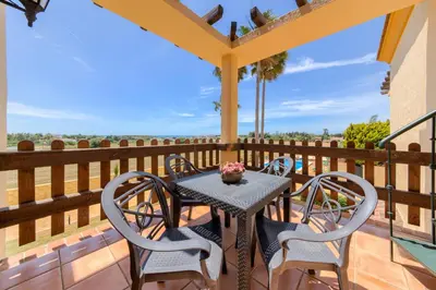 a table and chairs on a balcony with a view at Apartamentos Villafaro Conil in Conil de la Frontera